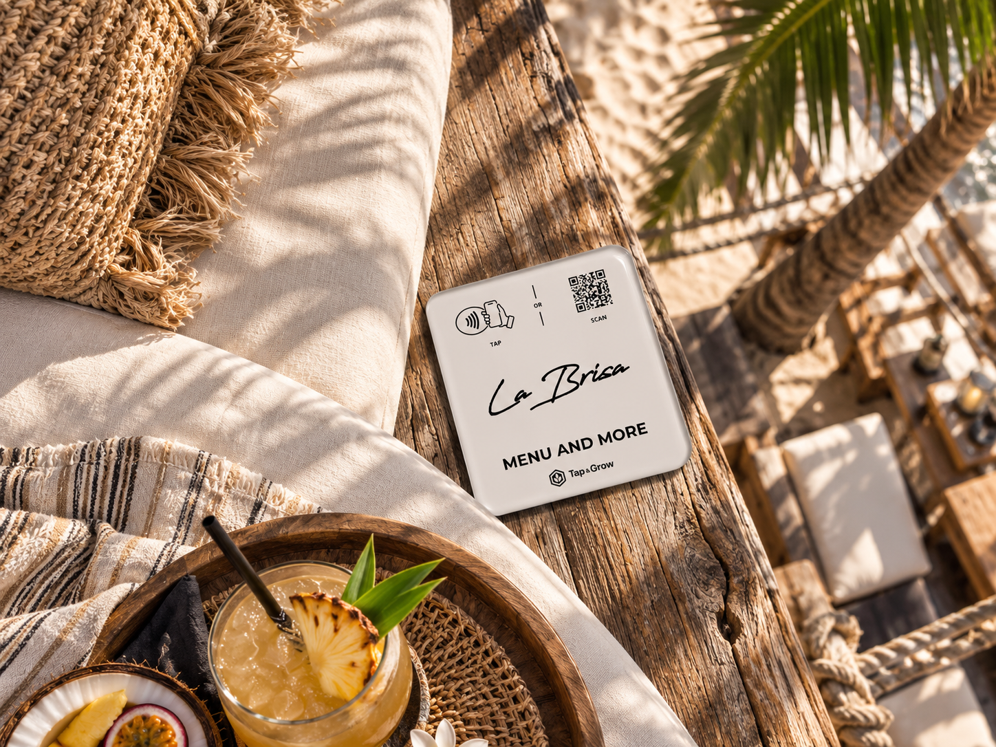 Tap and Grow NFC menu concept beside a La Brisa daybed and drink